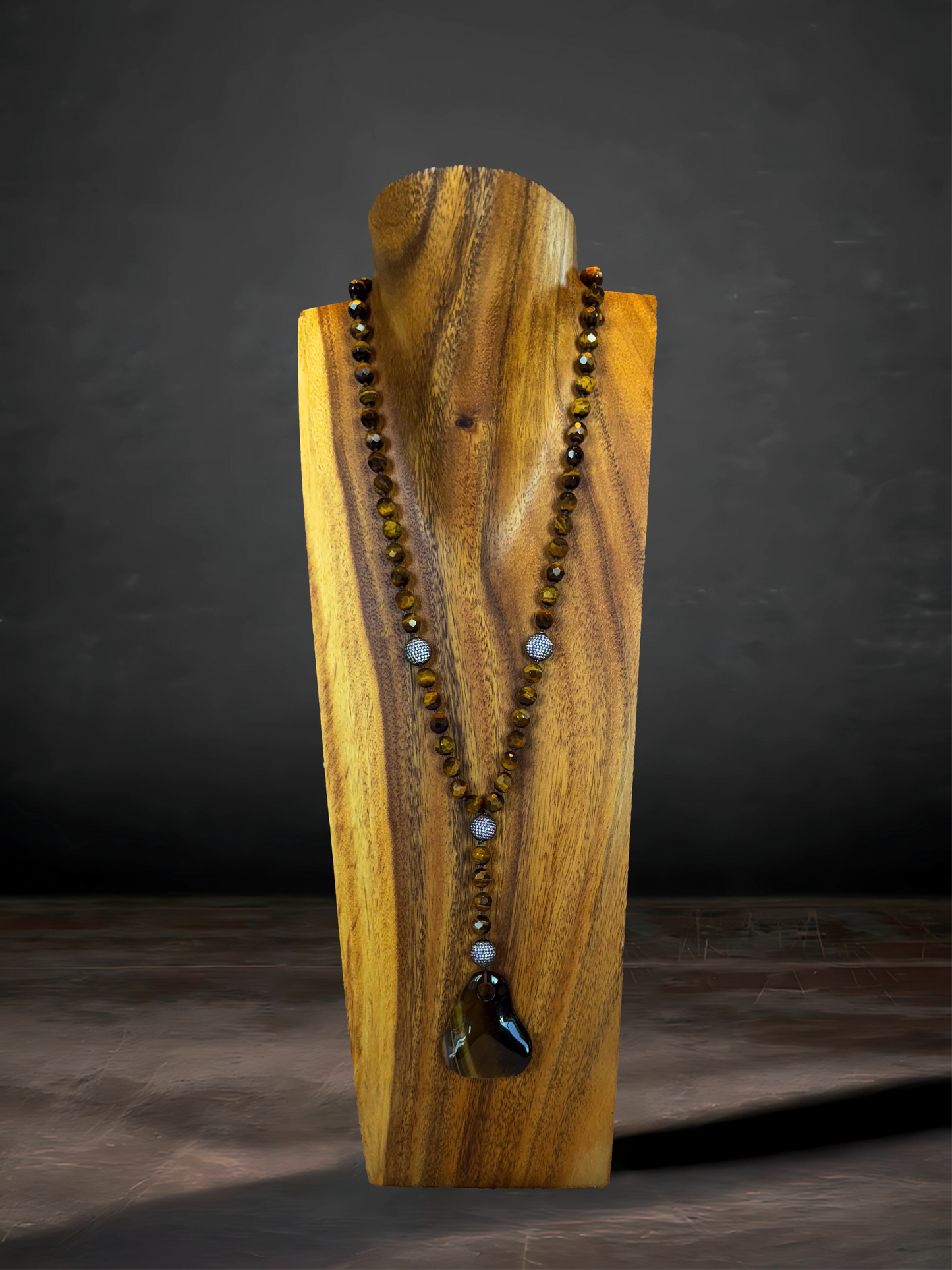 Tiger's eye necklace with a pendant and CZ accents, radiating warmth and sophistication.