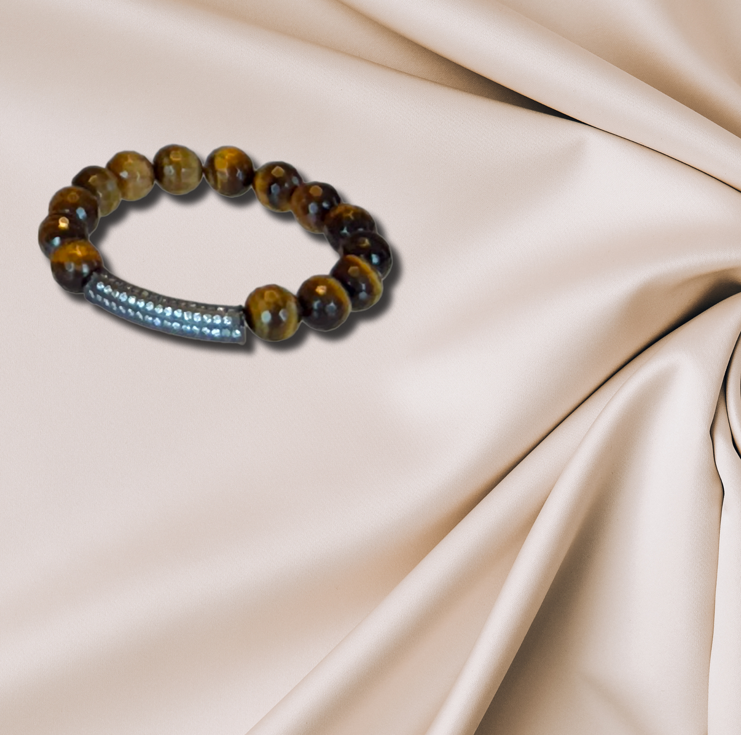 A tiger’s eye bracelet with a CZ bar, combining earthy tones with a modern touch.