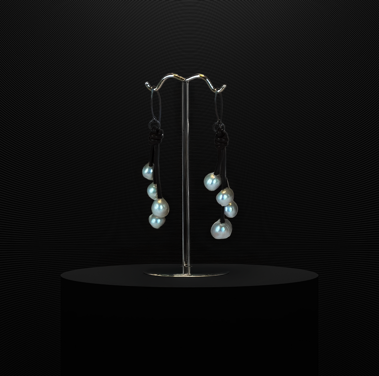 Four freshwater pearls on green leather with sterling silver wire.