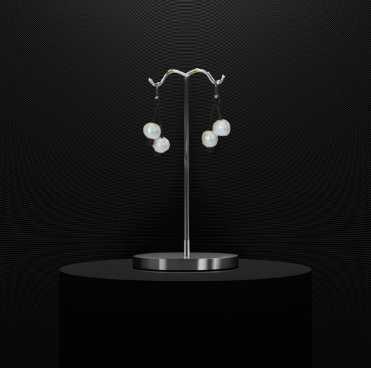 Double freshwater pearl drop earrings on Greek leather with sterling silver wire.