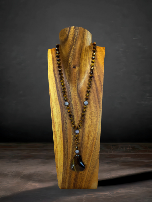 Tiger's eye necklace with a pendant and CZ accents, radiating warmth and sophistication.