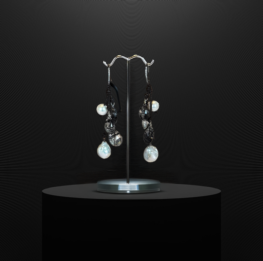 Freshwater pearl earrings with quartz drops on Greek leather, blending natural materials with a touch of elegance.
