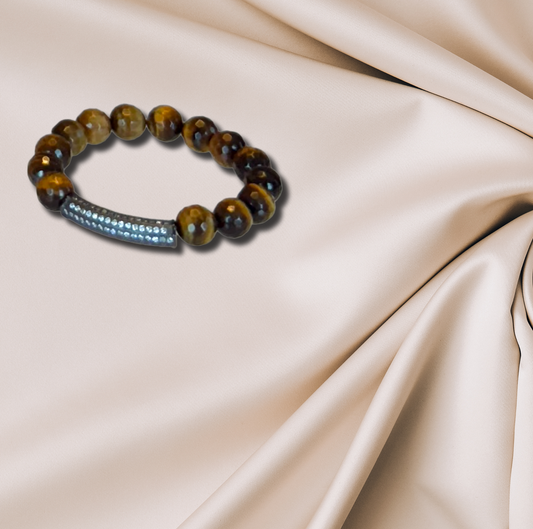 A tiger’s eye bracelet with a CZ bar, combining earthy tones with a modern touch.