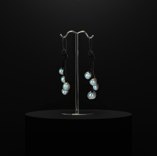 Four freshwater pearls on green leather with sterling silver wire.